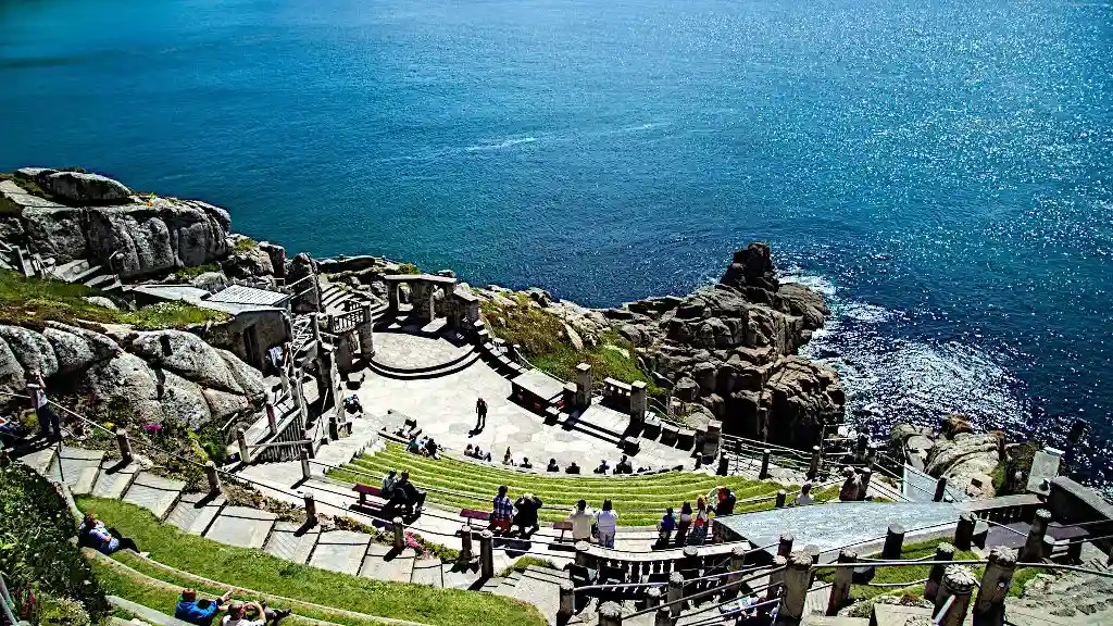 The Minack Theatre stage built into the cliffs with rocks and the ocean in the background