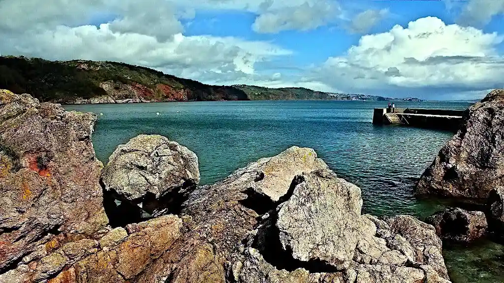 Rocky coast, bay with pier and view of the cliffs opposite