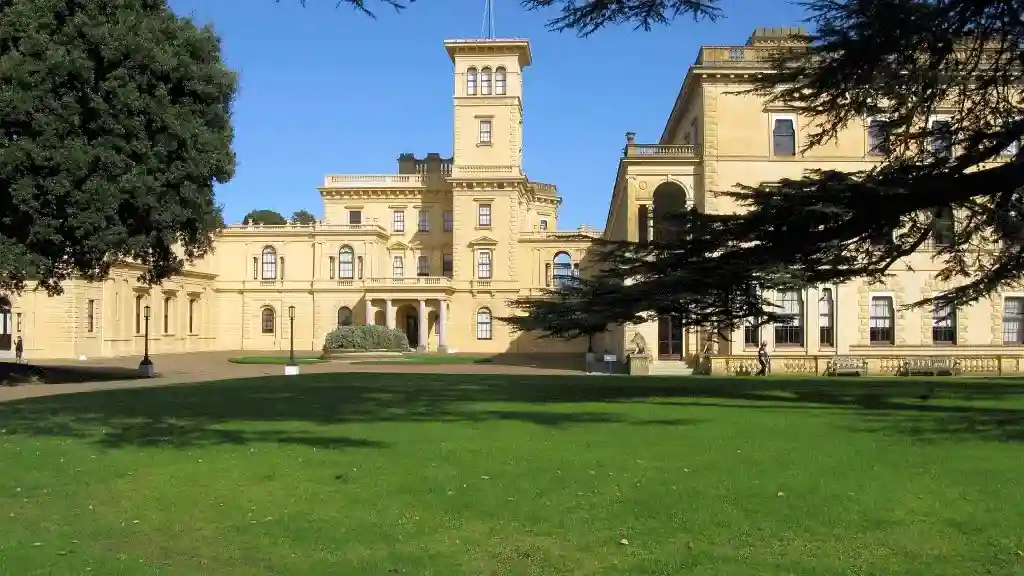 Front of Osborne house with green grass and trees