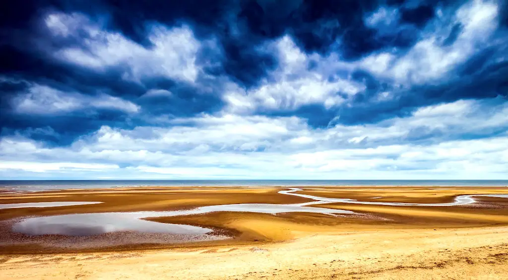 Dramatic view over mud flats and cloudy skies in Norfolk