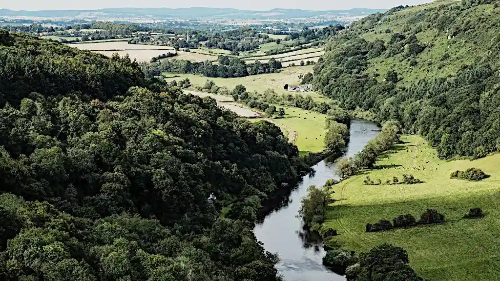 River meandering along wooded hills through the green Wye valley